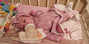 Paisley is registered to the contest to win money with this photo: baby, bottle, crib, diaper, pink_outfit, headband, socks, baby_supplies, blanket, infant, sleeping_area, feeding, child, bed, soft_toys, cute, indoors, resting, newborn, cozy