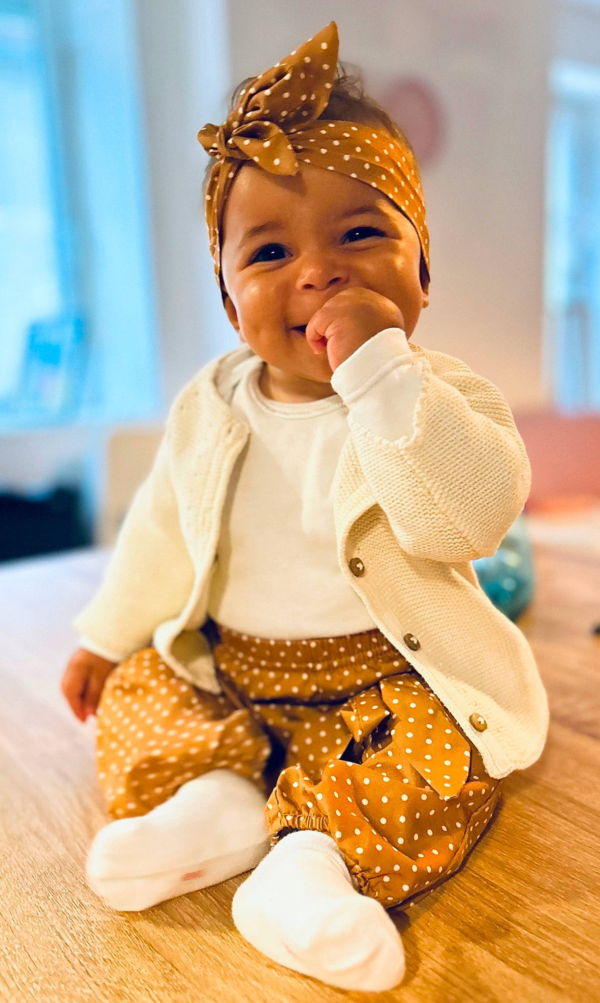 Maddy participe au concours pour gagner de l'argent avec cette photo : art, baby_toddler_clothing, cap, child, doll, event, fashion_accessory, fashion_design, fun, happy, headgear, joy, pattern, peach, person, sitting, skin, sleeve, smile, toddler