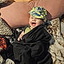 baby, babylaughing, bed, blanket, cap, clothing, couch, cushion, face, furniture, happy, hat, head, homedecor, laughing, person, photography, portrait, quilt, smile