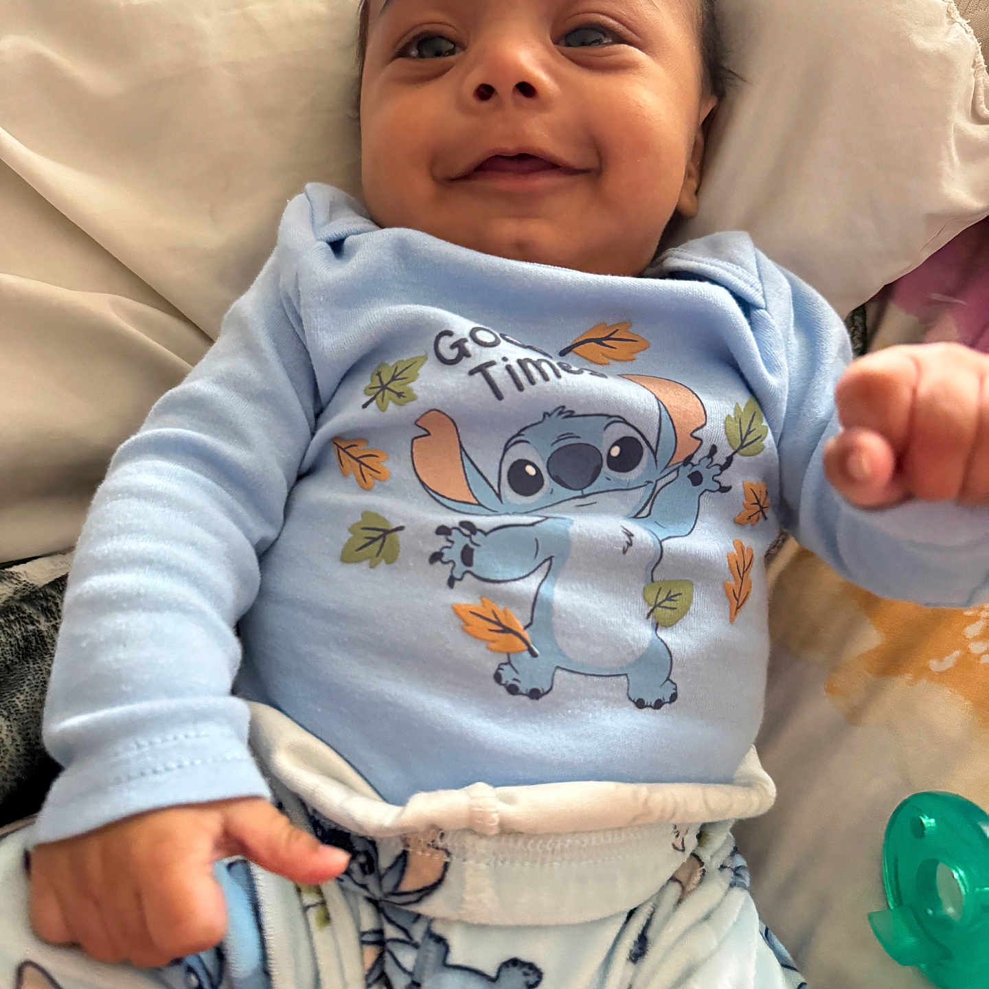 Amari joined the competition — help win amazing prizes! baby, bed, blanket, blue_clothing, cartoon_character, child, comfort, cute, face, hand, happy, indoors, infant, pacifier, pajamas, person, sleepwear, smiling, soft, young_child