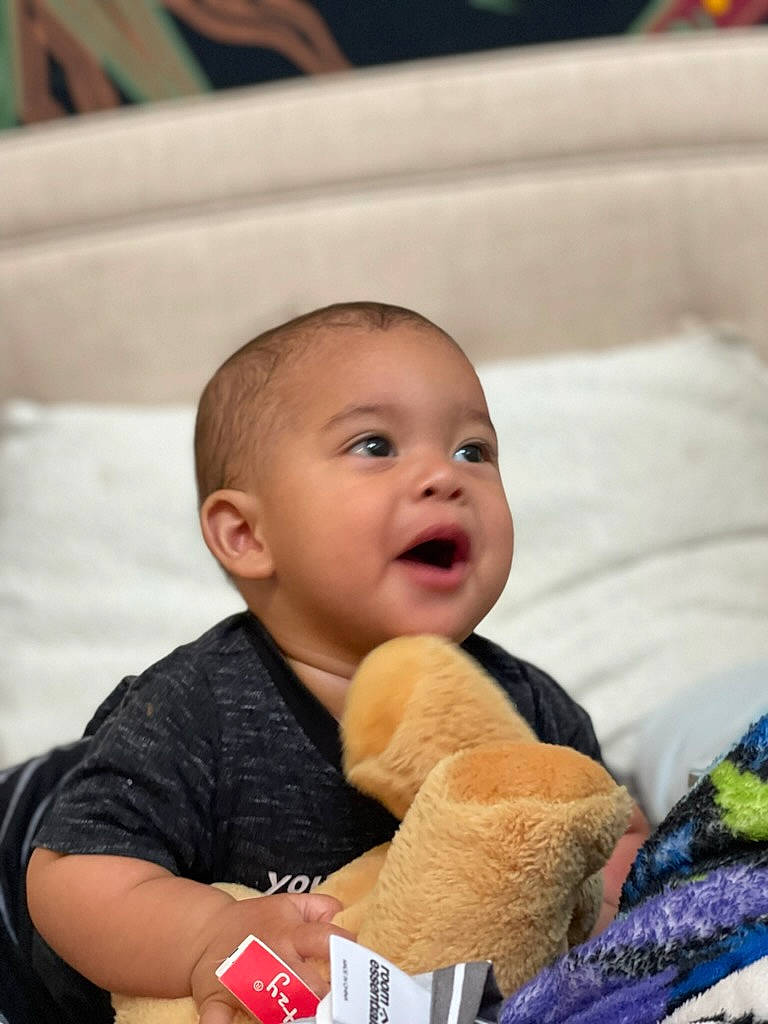 Ja'Zahny is registered to the contest to win money with this photo: baby, baby_products, cheek, child, comfort, eye, fun, fur, happy, linens, nose, people, person, play, room, sitting, smile, stuffed_toy, teddy_bear, toddler