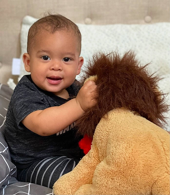 Ja'Zahny is registered to the contest to win money with this photo: abdomen, arm, baby, baby_toddler_clothing, child, comfort, companion_dog, fun, fur, gesture, happy, person, sitting, skin, smile, tableware, thigh, thumb, toddler, toy