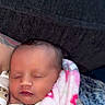 adult, arm, baby, blanket, close_up, closed_eyes, couch, cozy, cuddling, face, indoors, infant, infant_clothing, newborn, peaceful, photography, pink_blanket, portrait, sleeping, tattoo