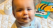 Kaden is registered to the contest to win money with this photo: baby, book, carpet, child, colorful, cute, face, floor, homedecor, indoor, infant, pajamas, person, playtime, quilt, sitting, smile, soft, toy, young
