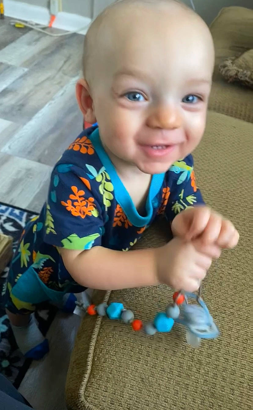 Kaizer is registered to the contest to win money with this photo: arm, baby, baby_toddler_clothing, cheek, cool, face, finger, flooring, fun, hand, happy, head, human_body, iris, joy, nose, person, skin, sleeve, smile