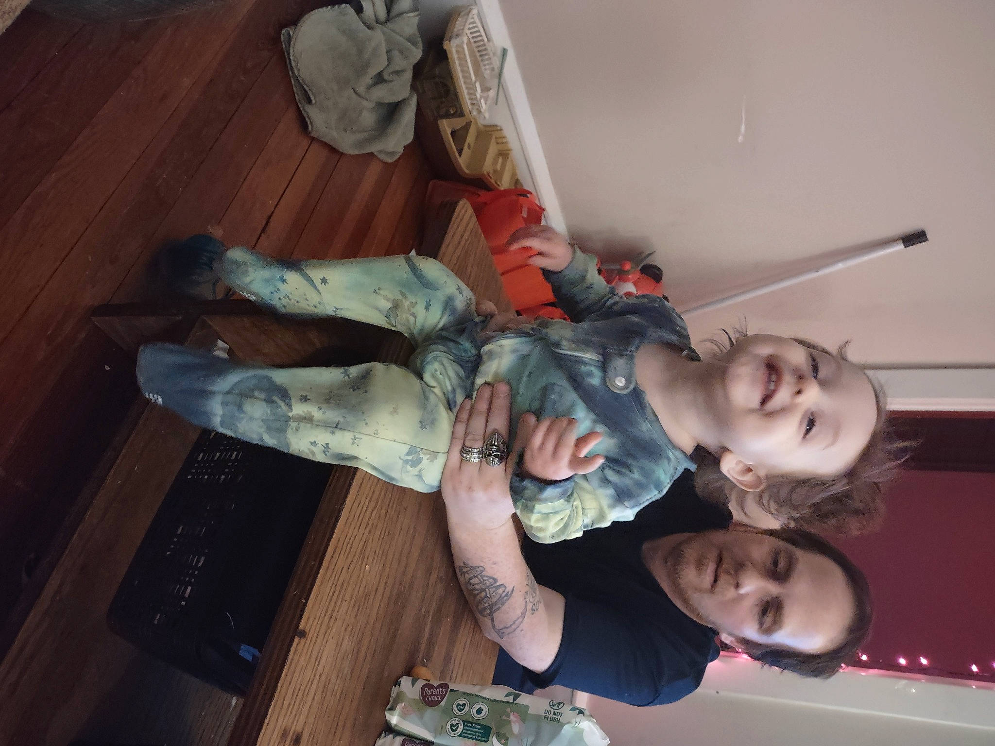 Miguel is registered to the contest to win money with this photo: baby, child, comfort, elbow, flesh, flooring, fun, happy, hardwood, human_leg, joy, knee, person, room, sandal, smile, sock, thigh, toddler, wood