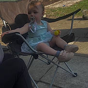 Azalea Ohler joined the competition — help win amazing prizes! toddler, child, pacifier, chair, outdoor, sunlight, dress, toy, footwear, concrete, fence, tree, shadow, grass, relaxing, play, person, casual, summer, nature