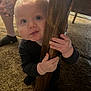 baby, child, curious, wood, table_leg, carpet, hand, foot, tattoo, indoor, person, crawling, grip, legs, close_up, cute, young, exploring, floor, home