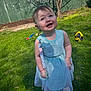 toddler, child, dress, blue_dress, smile, outdoor, grass, sunlight, toy, happy, person, footwear, nature, fence, tree, daylight, playtime, cute, young_child, greenery