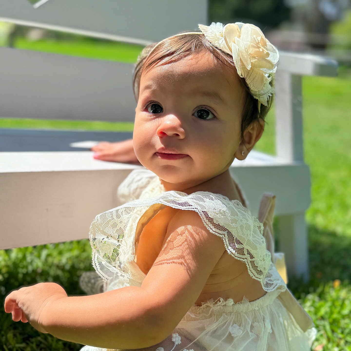 Priscilla is registered to the contest to win money with this photo: baby, bodypart, clothing, dress, eveningdress, face, finger, flower, flowerarrangement, formalwear, grass, hand, hat, head, lawn, person, photography, plant, portrait, sitting
