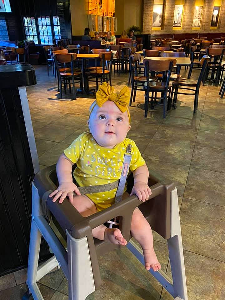 Joann joined the competition — help win amazing prizes! baby_toddler_clothing, chair, child, comfort, flooring, fun, furniture, human_leg, lap, leg, leisure, person, shoe, shorts, sitting, sneakers, table, thigh, toddler, wood