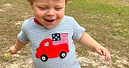 Nolan joined the competition — help win amazing prizes! toddler, child, running, outdoor, grass, shirt, red_shorts, blond_hair, happy, smiling, woman, cooler, casual_clothing, daylight, nature, trees, playful, person, young_child, fun