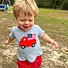 toddler, child, running, outdoor, grass, shirt, red_shorts, blond_hair, happy, smiling, woman, cooler, casual_clothing, daylight, nature, trees, playful, person, young_child, fun