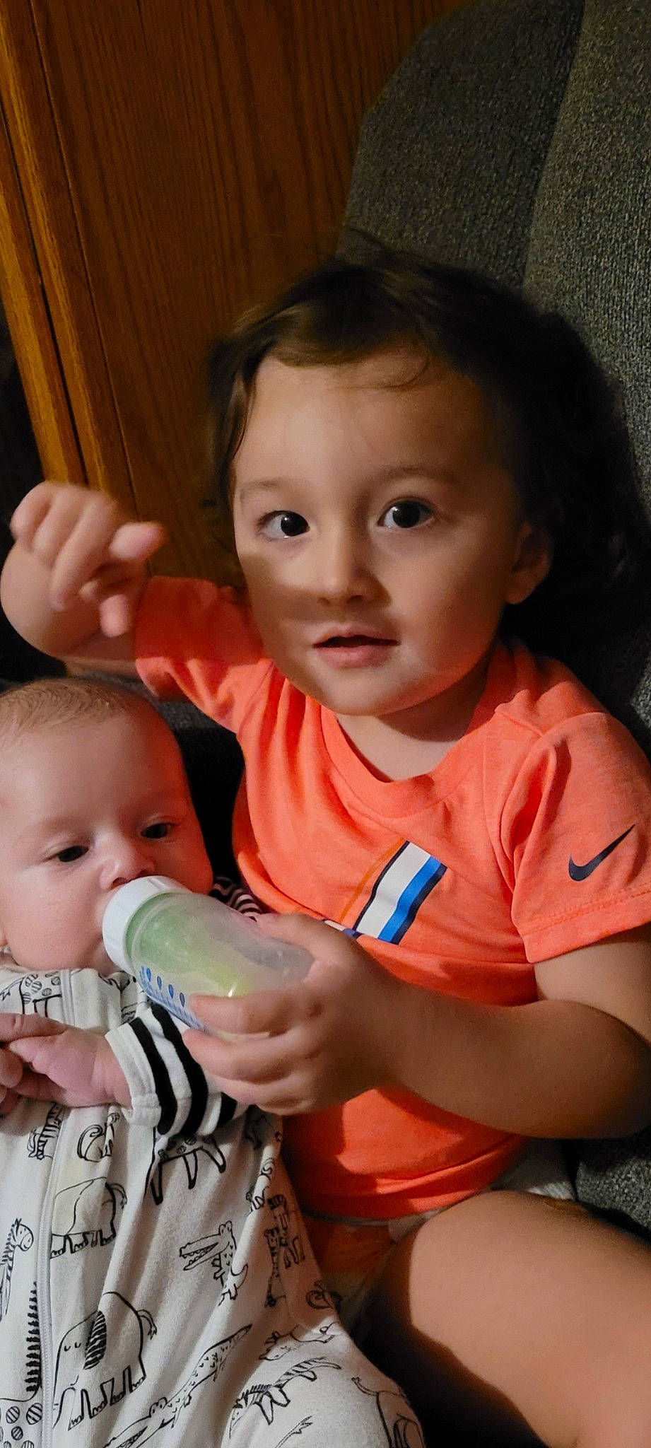 Jaxson is registered to the contest to win money with this photo: arm, baby_bottle, bottle, cheek, chin, drinkware, ear, eye, face, finger, gesture, hair, hand, happy, head, iris, mouth, nose, organ, person