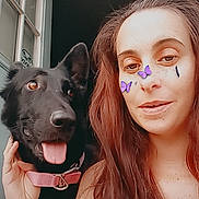 Phoebe joined the competition — help win amazing prizes! woman, dog, black_dog, selfie, indoor, long_hair, pink_collar, digital_stickers, butterfly_stickers, tongue_out, pet, casual, tattoo, smiling, face, hand, window, hair, portrait, friendly