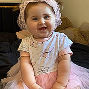 Sienna a rejoint le concours — aidez-le/la à gagner de superbes lots ! baby, bed, butterfly, child, clothing, cute, dress, happy, headband, indoor, infant, lace, person, pigtails, pink, plush_toy, portrait, sitting, smile, tutu