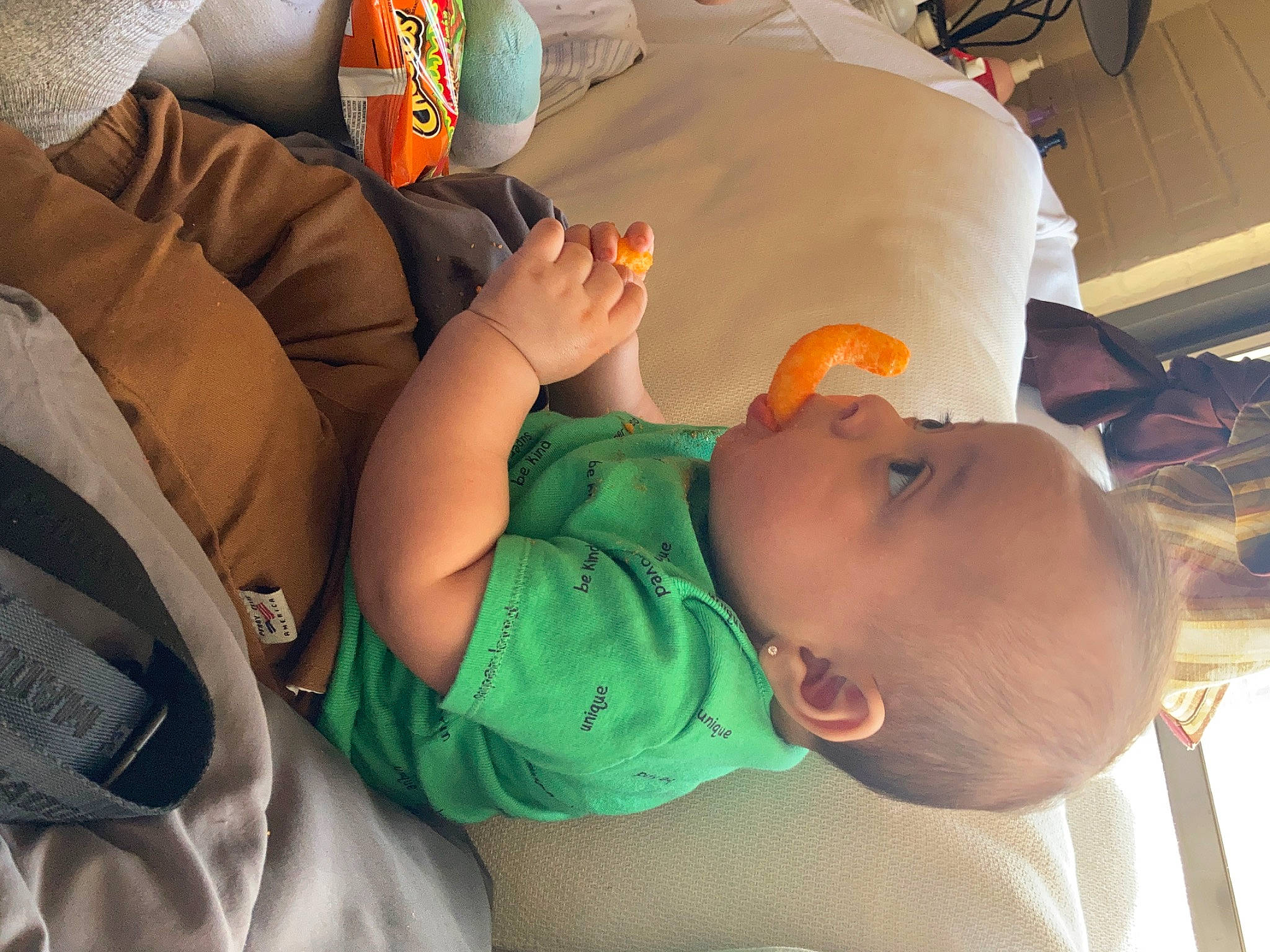 Demetrius is registered to the contest to win money with this photo: baby, baby_products, baby_toddler_clothing, bag, child, comfort, elbow, finger, fun, hand, hat, human_body, joint, mouth, nail, nap, orange, person, room, t_shirt