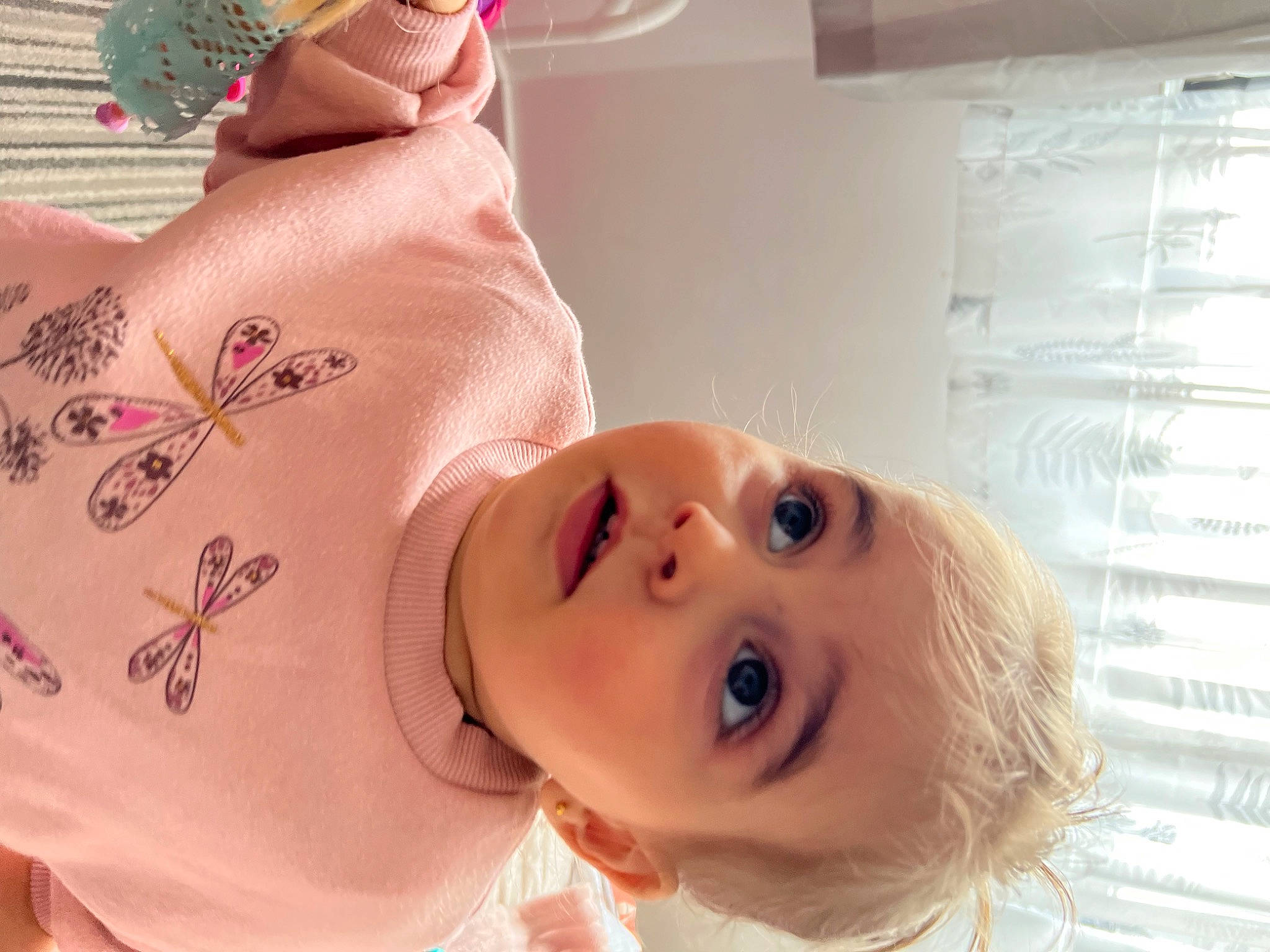 Aylin is registered to the contest to win money with this photo: baby, baby_toddler_clothing, cheek, chest, child, ear, eyebrow, eyelash, happy, lip, mouth, neck, nose, person, pink, room, skin, sleeve, smile, surprise