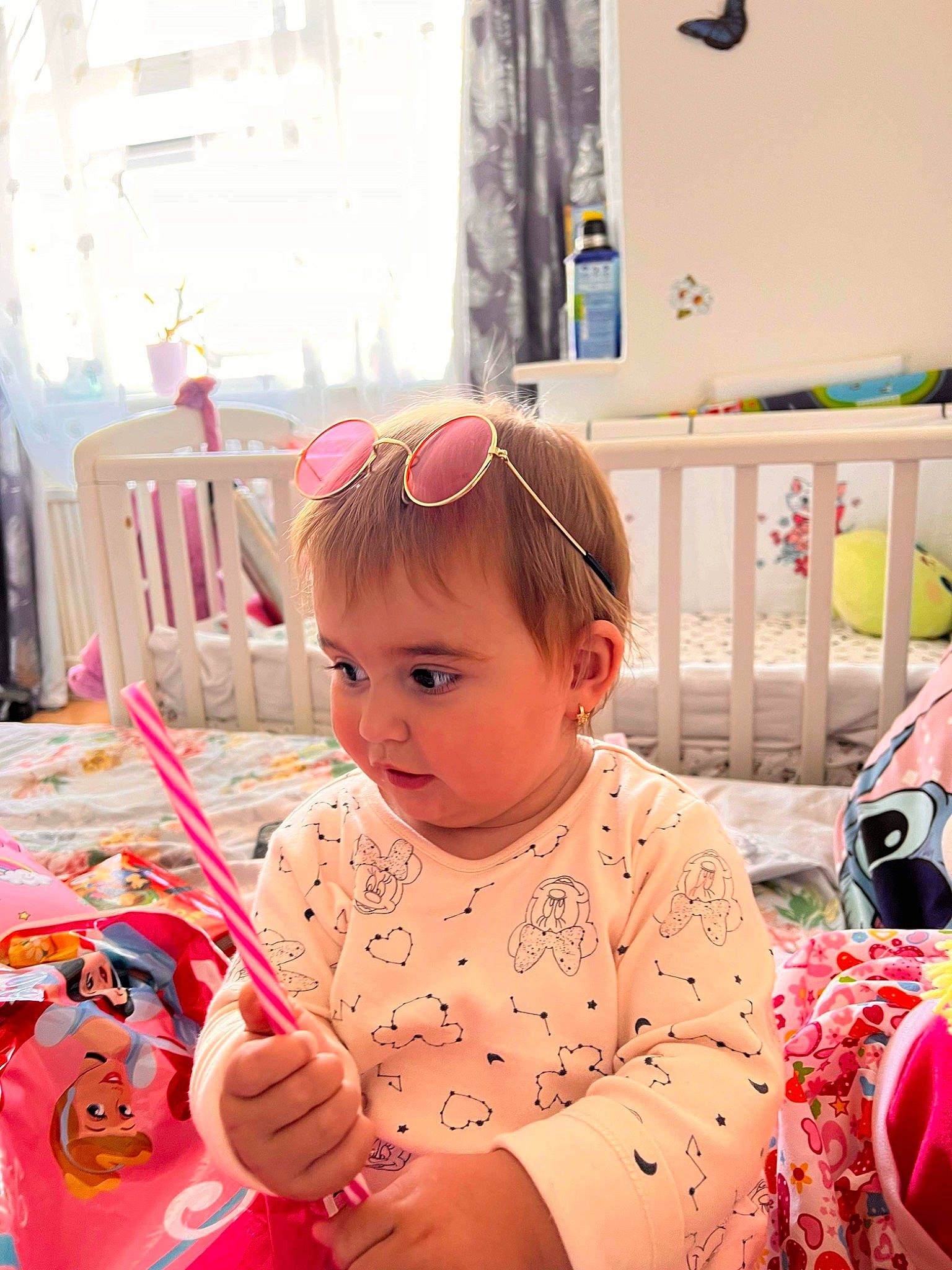 Aylin is registered to the contest to win money with this photo: baby, baby_toddler_clothing, chair, child, eyewear, fun, happy, learning, magenta, person, pink, play, room, sitting, sunglasses, toddler, vacation, window