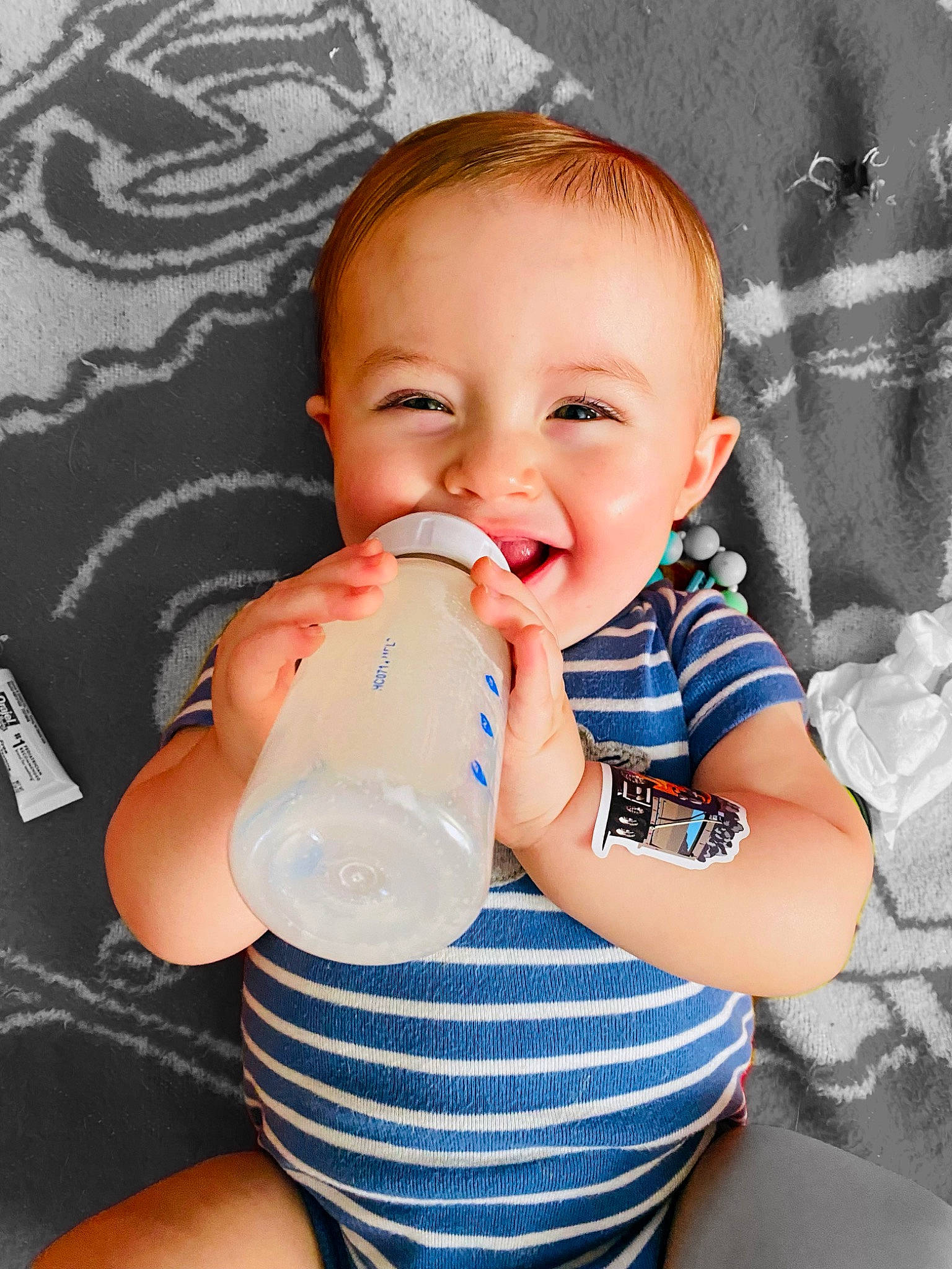 Levi joined the competition — help win amazing prizes! arm, baby, baby_bottle, baby_toddler_clothing, blue, cheek, drinking, drinkware, finger, happy, mouth, neck, nose, person, plastic_bottle, product, skin, smile, textile, toddler