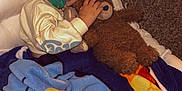 Easton is registered to the contest to win money with this photo: child, teddy_bear, blanket, pacifier, chair, carpet, indoor, cute, cozy, sleepwear, toy, smiling, person, young_child, snuggling, plush, comfort, home, relaxing, portrait
