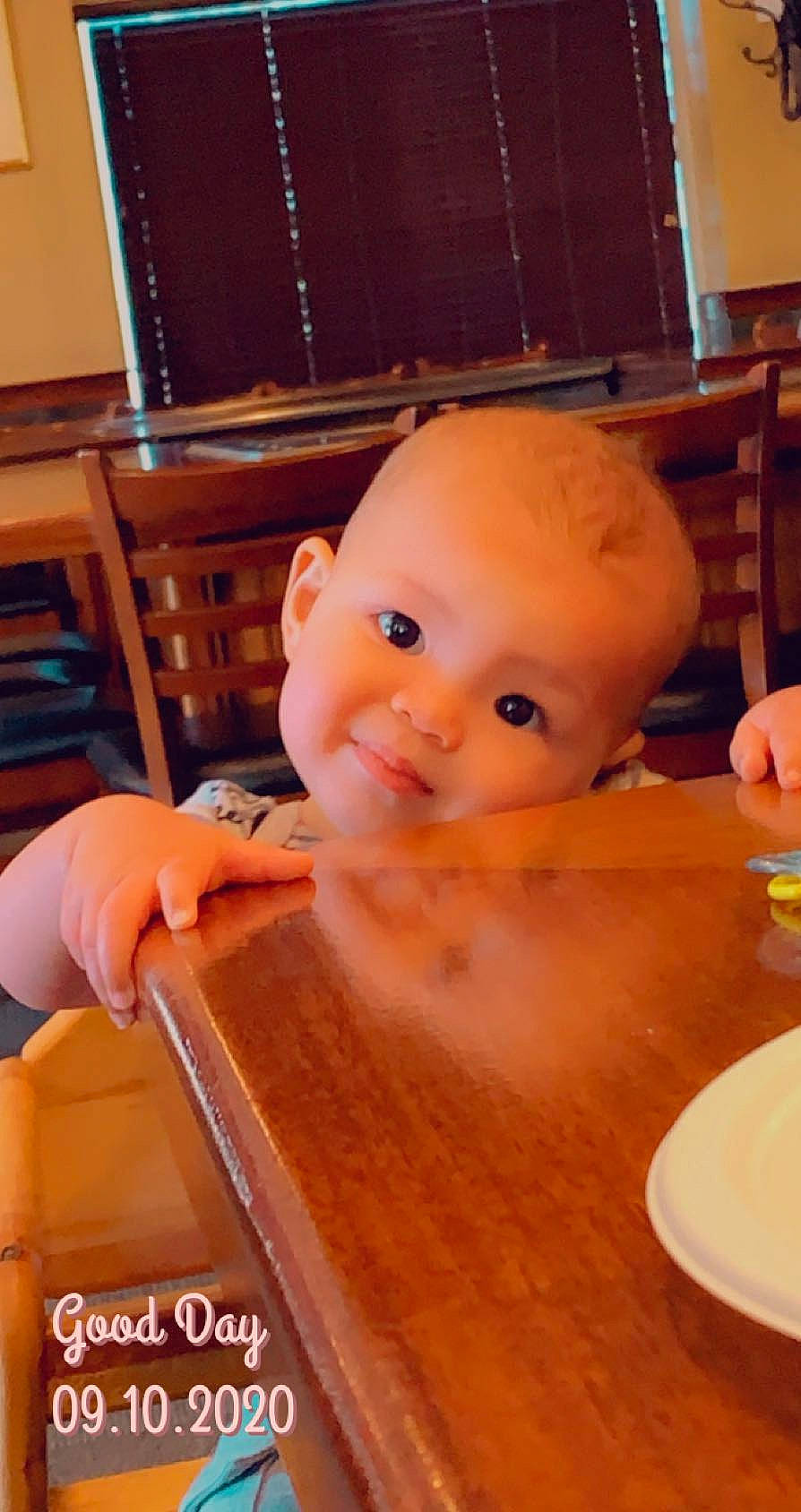 Demetrius is registered to the contest to win money with this photo: baby, chair, cheek, child, comfort_food, cuisine, eyelash, finger, flooring, hardwood, nail, person, plastic, room, smile, table, tableware, thumb, toddler, toy