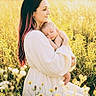 woman, baby, infant, field, wildflowers, nature, sunlight, golden_hour, outdoor, portrait, mother, child, holding, dress, peaceful, sleeping, grass, flower, tender, warm