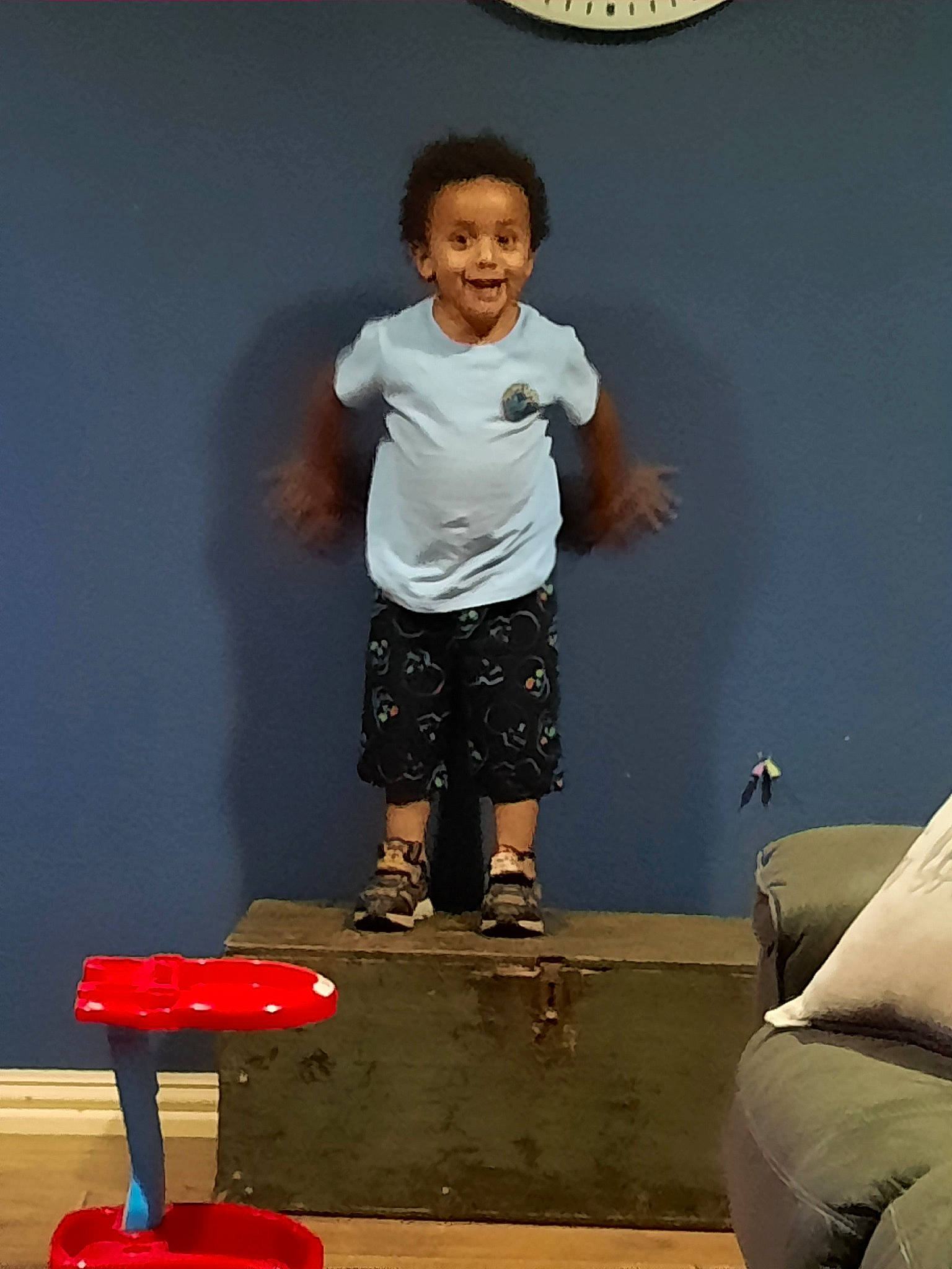 Ivory is registered to the contest to win money with this photo: balance, clock, elbow, electric_blue, flooring, fun, happy, human_leg, joint, joy, knee, person, red, room, shorts, shoulder, sitting, sleeve, smile, standing