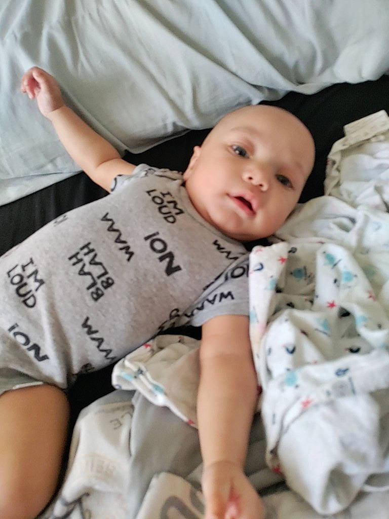 Brandon Jr is registered to the contest to win money with this photo: baby, baby_toddler_clothing, cheek, child, comfort, elbow, happy, linens, mammal, pattern, person, portrait_photography, product, sitting, skin, sleeve, smile, t_shirt, textile, toddler