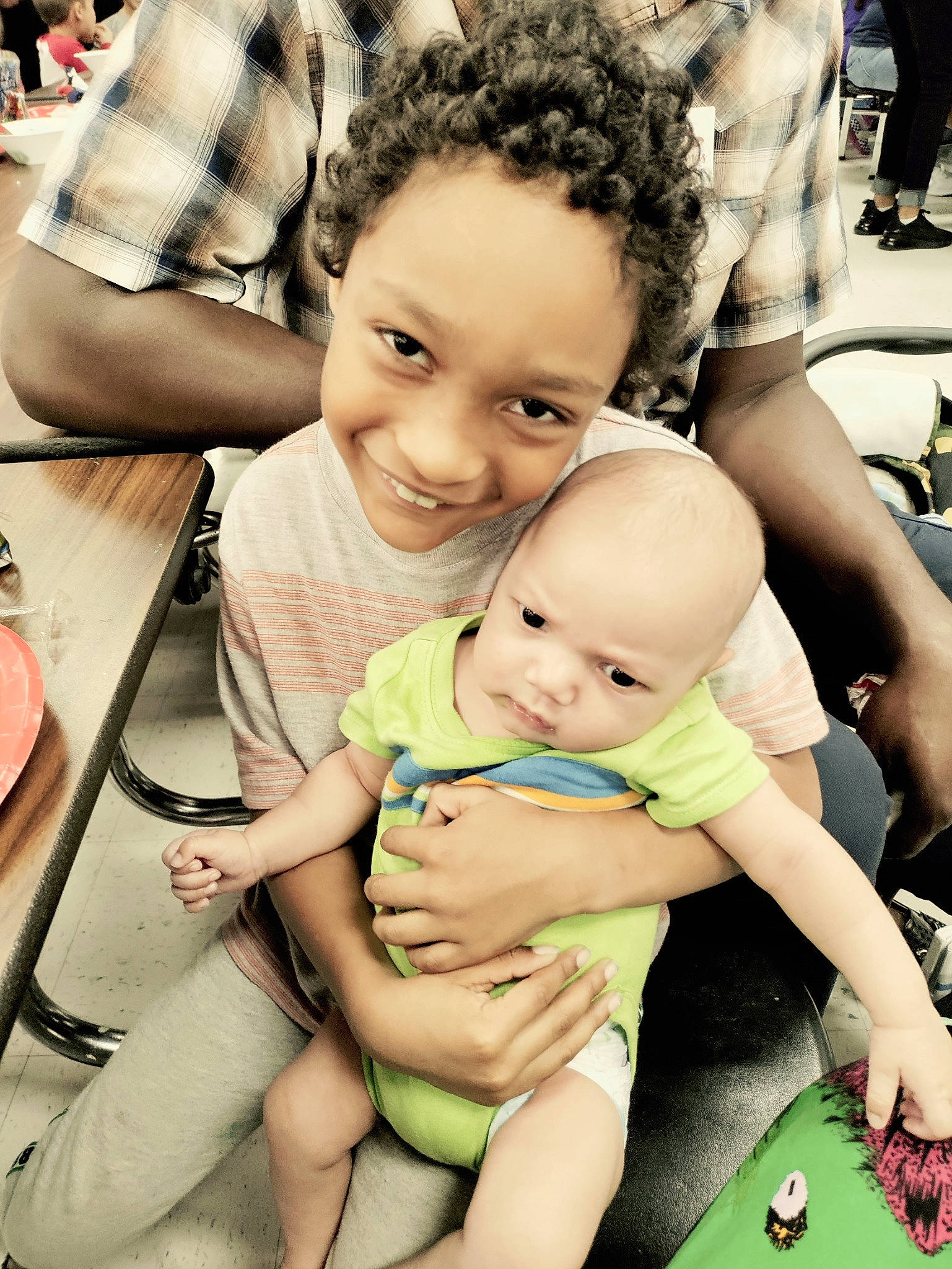 Brandon is registered to the contest to win money with this photo: adaptation, arm, chair, facial_expression, finger, fun, hairstyle, happy, interaction, joy, leisure, mammal, person, photograph, product, shorts, skin, smile, summer, table