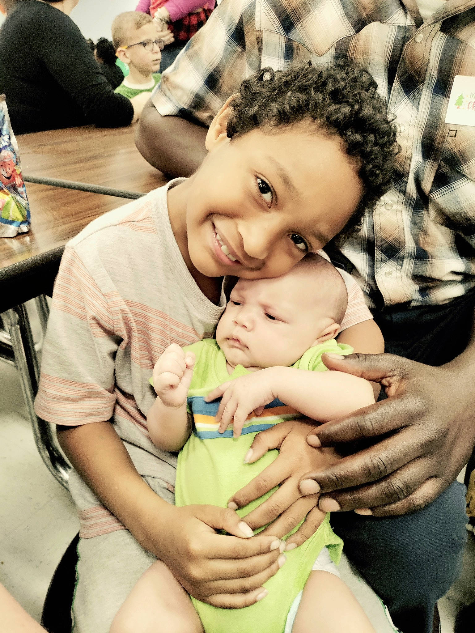 Brandon is registered to the contest to win money with this photo: abdomen, baby, chair, cheek, child, comfort, eye, finger, fun, gesture, happy, joy, leisure, people_in_nature, person, photograph, skin, smile, table, thigh