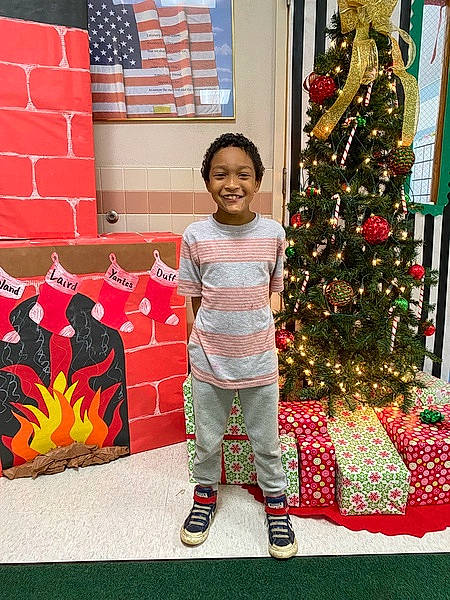 Brandon joined the competition — help win amazing prizes! christmas_decoration, christmas_eve, christmas_ornament, christmas_tree, event, evergreen, flag, fun, happy, holiday, holiday_ornament, joy, ornament, pattern, person, red, room, smile, standing, textile