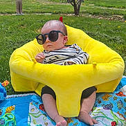 Declan is registered to the contest to win money with this photo: accessories, baby, backyard, face, furniture, glasses, grass, head, nature, outdoors, park, person, photography, plant, portrait, summer, sunglasses, tree, vegetation, yard