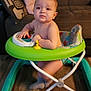 Rafael is registered to the contest to win money with this photo: baby, child, colorful, couch, cozy, curious, expression, floor, furniture, home, indoor, infant, living_room, person, pillow, sitting, toy, walker, wooden_floor, young_child