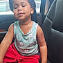 Trulia joined the competition — help win amazing prizes! child, cap, tank_top, red_shorts, car_seat, vehicle_interior, seat, person, young_child, casual_clothing, relaxed, sitting, indoor, smiling, black_hair, wristband, window, daylight, trees, car