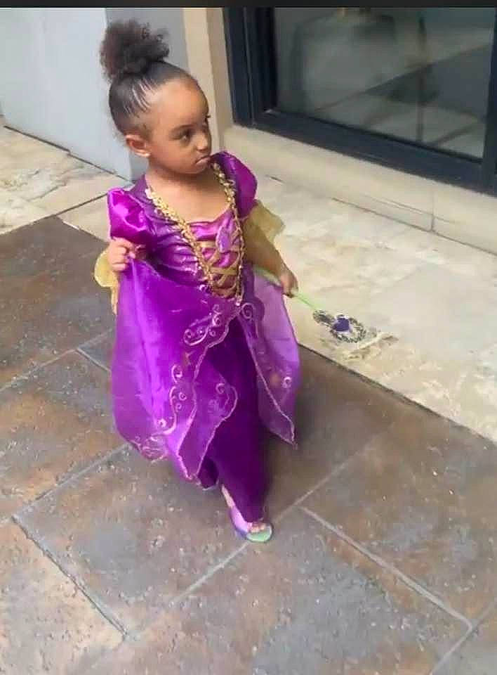 Bailee is registered to the contest to win money with this photo: baby, baby_toddler_clothing, child, concrete, costume, day_dress, dress, embellishment, face, fashion_accessory, fashion_design, floor, flooring, formal_wear, fun, magenta, person, purple, sitting, toddler