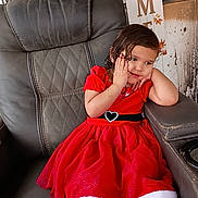 Alaya joined the competition — help win amazing prizes! child, girl, red_dress, heart_belt, leather_chair, sitting, thoughtful, indoors, portrait, brown_hair, cute, young, furniture, window, decor, holiday_dress, fashion, expression, pose, casual