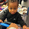 Jasiah is registered to the contest to win money with this photo: toddler, child, shopping_cart, grocery_store, braided_hair, black_clothing, white_shoes, hand, aisle, shelves, products, adult, shopping, supermarket, person, indoor, store, cute, pout, expression