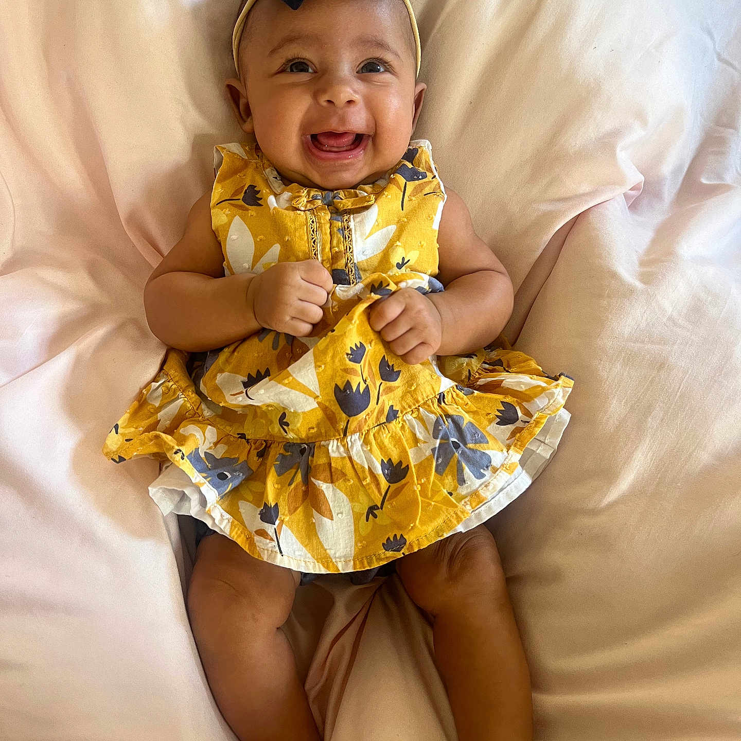 Aliya is registered to the contest to win money with this photo: baby, babylaughing, baseballcap, bed, cap, clothing, cushion, dress, face, furniture, happy, hat, head, homedecor, laughing, person, photography, portrait, sitting, smile