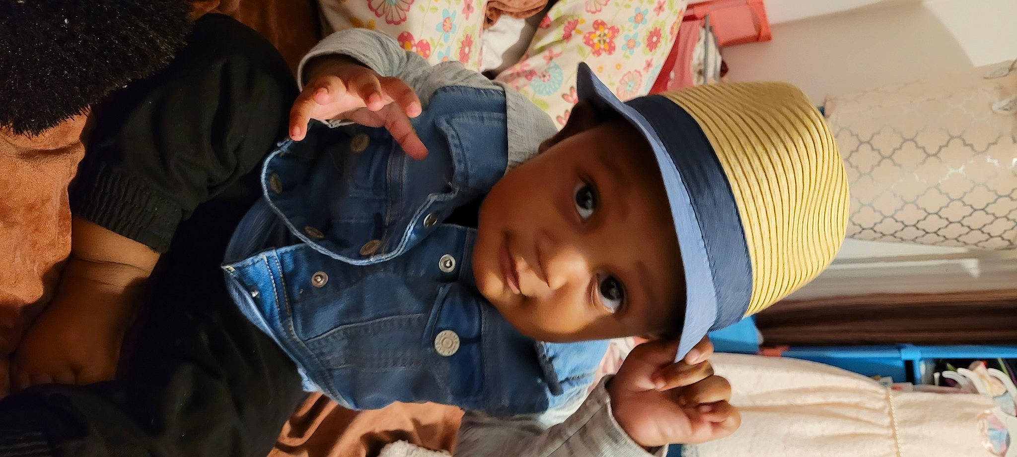 Khai is registered to the contest to win money with this photo: baby, beanie, cap, cheek, child, comfort, cool, fashion_accessory, fun, happy, hat, headgear, headwear, leisure, person, portrait_photography, room, sitting, skin, street_fashion