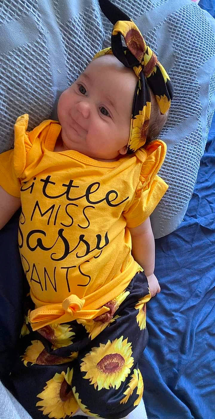 Ember joined the competition — help win amazing prizes! abdomen, baby, baby_products, baby_toddler_clothing, child, comfort, fun, happy, head, headwear, human_body, linens, orange, pattern, person, plant, sleeve, t_shirt, textile, toddler