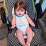 Jaxson is registered to the contest to win money with this photo: baby, child, infant, portrait, sitting, bouncer, baby_seat, giraffe, onesie, patterned_fabric, red_hair, blue_eyes, wide_eyed, outdoor, deck, wooden_floor, chair, feet, casual, safe