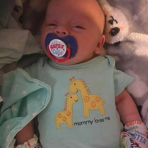 Alexander is registered to the contest to win money with this photo: baby, baby_toddler_clothing, cheek, child, comfort, cool, eye, finger, happy, linens, mouth, neck, nose, pink, skin, sleeve, t_shirt, textile, toddler, white