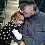 child, elderly_man, hug, love, clothing_store, jackets, shirts, shopping, glasses, cap, smile, polka_dot, sweater, hand, hanger, warm_clothing, indoor, people, affection, bond