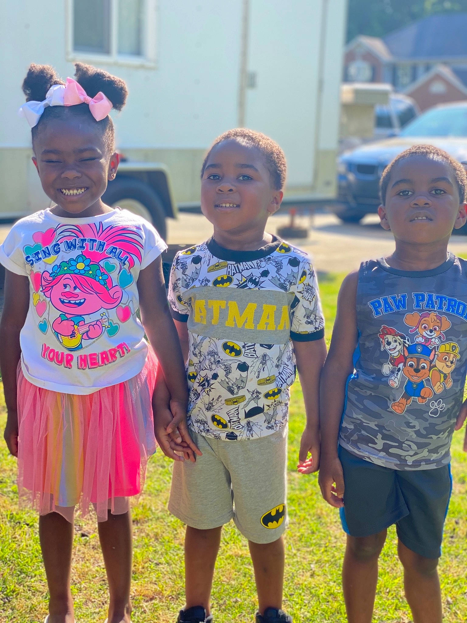 Kyree is registered to the contest to win money with this photo: child, clothing, community, event, facial_expression, fun, grass, happy, hat, joy, leisure, person, plant, recreation, shorts, smile, social_group, standing, summer, t_shirt