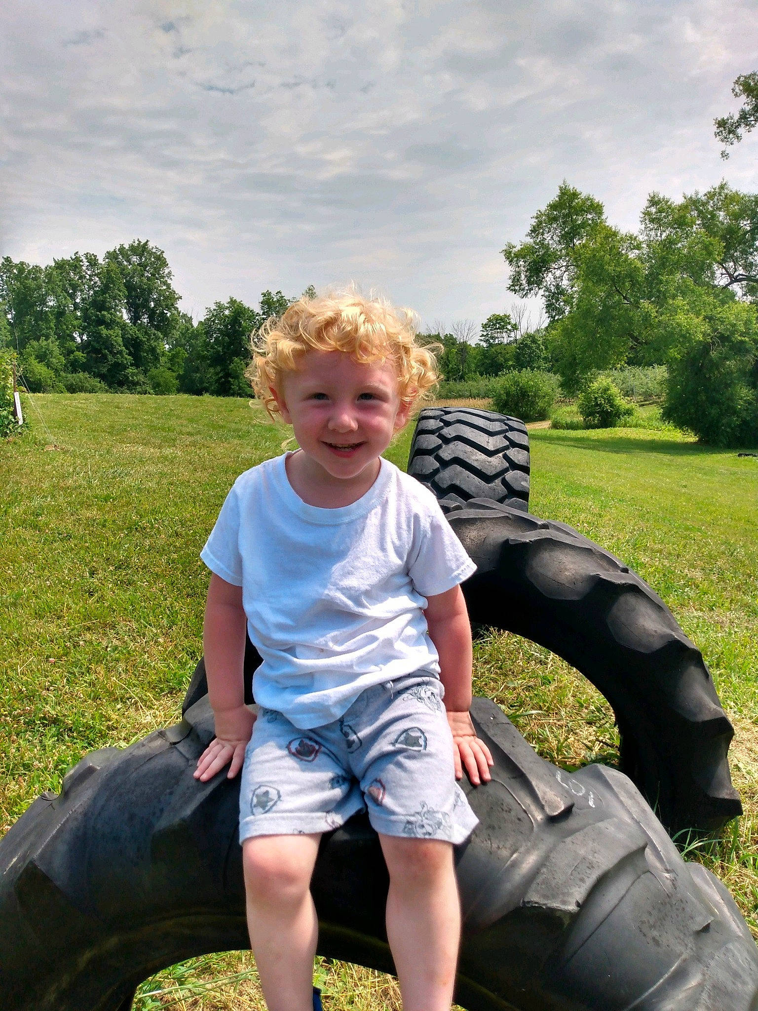 Dustin joined the competition — help win amazing prizes! automotive_tire, cloud, cool, facial_expression, flash_photography, grass, hairstyle, happy, human_body, joy, leisure, person, photograph, plant, sky, smile, sunlight, synthetic_rubber, t_shirt, tire