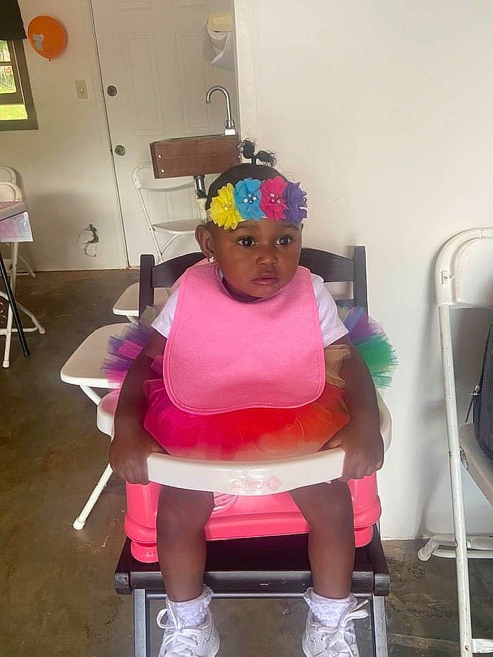 Kelani is registered to the contest to win money with this photo: balance, chair, costume, eyewear, fashion_accessory, fashion_design, flooring, head, headgear, headwear, human_leg, knee, leisure, magenta, person, personal_protective_equipment, pink, room, sandal, shorts