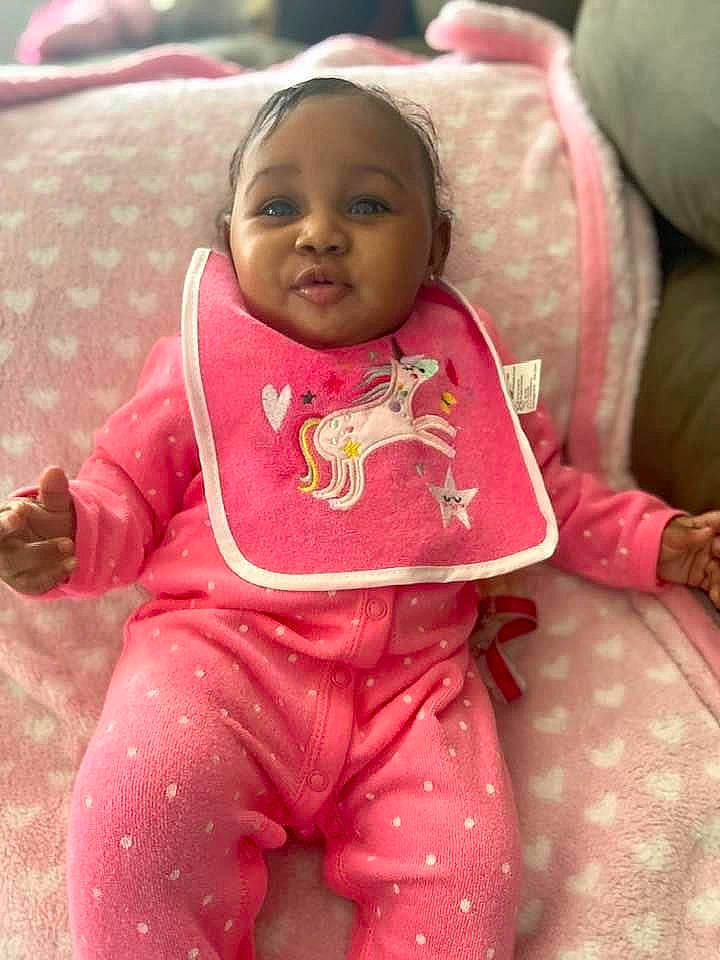 Kelani joined the competition — help win amazing prizes! baby, baby_products, baby_toddler_clothing, cheek, child, comfort, flooring, fun, happy, linens, magenta, person, pink, room, sitting, skin, sleeve, smile, textile, toddler