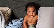 Atlantic joined the competition — help win amazing prizes! baby, child, bed, pillow, blanket, soft_toy, curly_hair, indoor, portrait, infant, cute, skin, expression, looking_at_camera, holding, cloth, headboard, resting, comfort, young