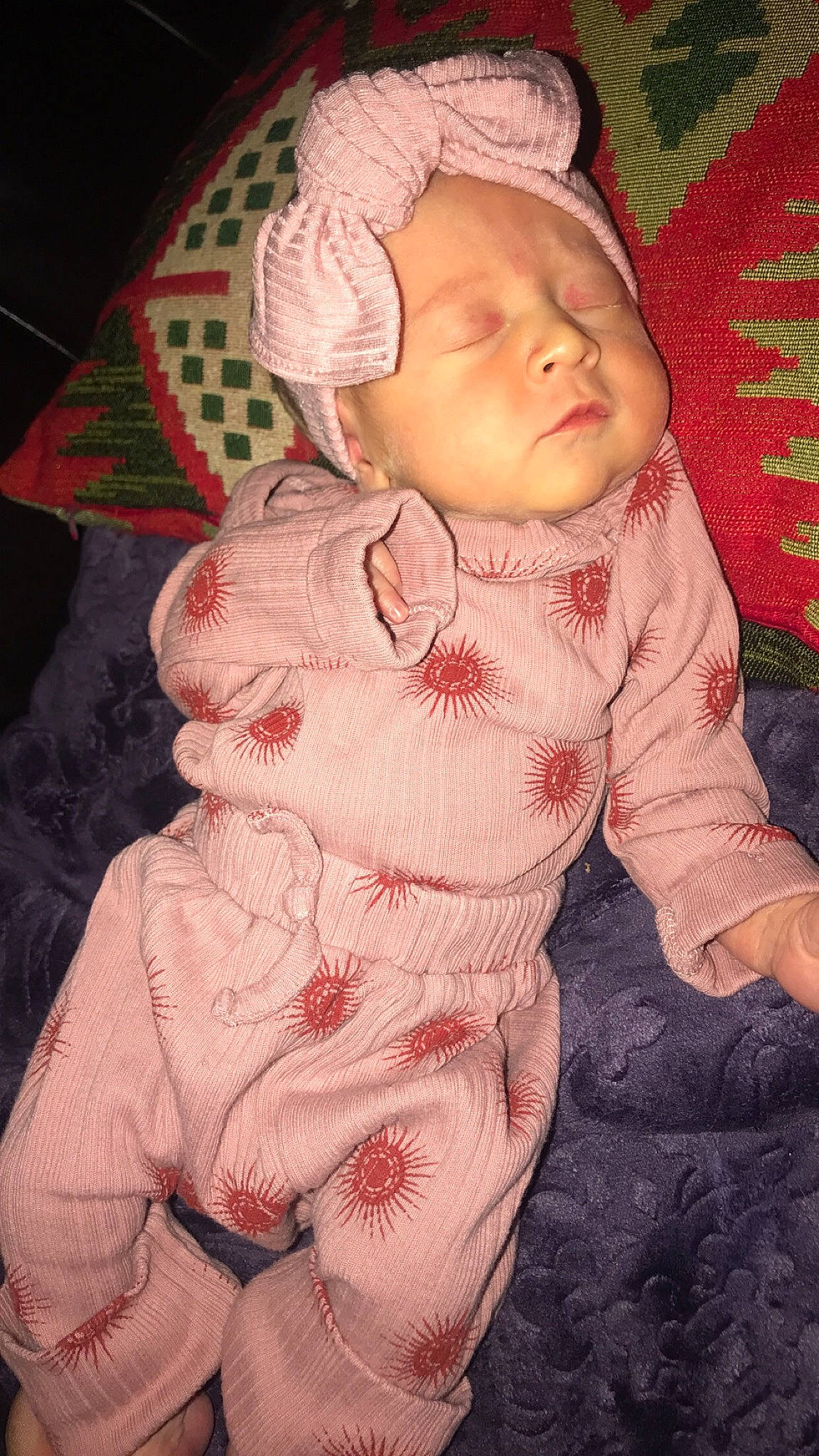 Hadley is registered to the contest to win money with this photo: baby, baby_toddler_clothing, cheek, child, comfort, eye, face, head, iris, linens, lip, nose, pattern, person, pink, sitting, skin, sleeve, textile, toddler